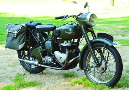 photo of a green bike with a swiss army knife sitting on the back pilon
